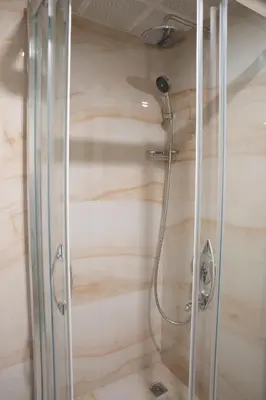 a shower with a glass enclosure in a bathroom at Alpinn Hotel DUE in Istanbul