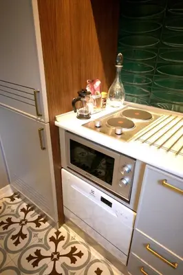 a kitchen with a stove top oven next to a refrigerator at Superior refurbished flat in the heart of Istanbul in Istanbul