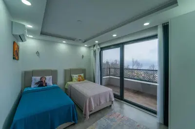 a bedroom with two beds and a large window at Sapanca villa in Sapanca