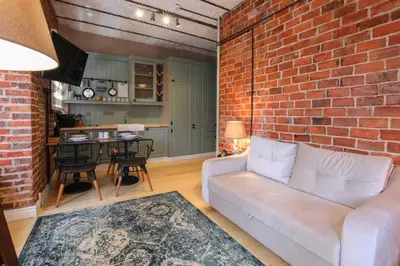 a living room with a couch and a brick wall at Galadoo Suites 3rd Floor in Istanbul