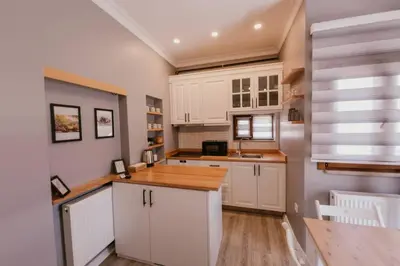 a kitchen with white cabinets and a wooden counter top at Galadoo Suites 4th Floor in Istanbul