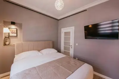 a bedroom with a bed and a flat screen tv at Galadoo Suites 4th Floor in Istanbul