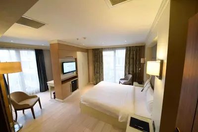 a hotel room with a bed and a television at Hotel Le Mirage in Istanbul