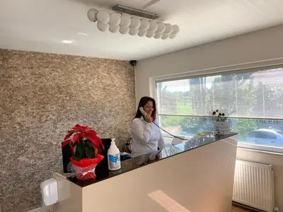 a woman talking on a cell phone in a kitchen at TALEN OTEL in Istanbul