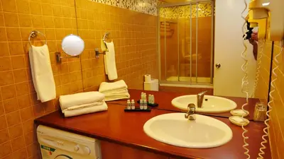 a bathroom with two sinks and a mirror at TALEN OTEL in Istanbul