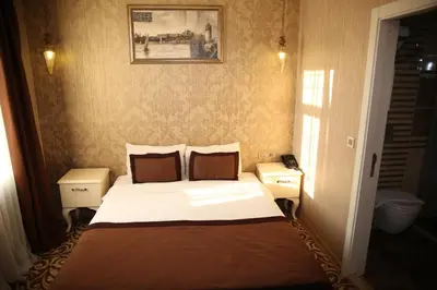 a small bedroom with a bed and two night stands at Montagna Hera Hotel Taksim in Istanbul
