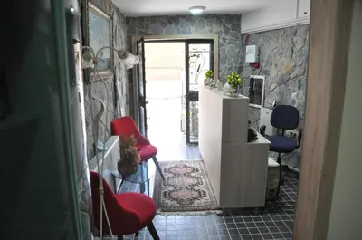a hallway with two red chairs and a counter at Rumeli Konak Butik Otel in Tekirdag