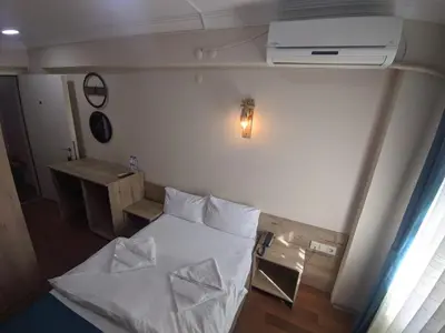 a small room with a bed with two pillows at Rumeli Konak Butik Otel in Tekirdag