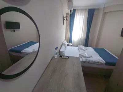 a mirror in a small room with a bed and a bedroom at Rumeli Konak Butik Otel in Tekirdag