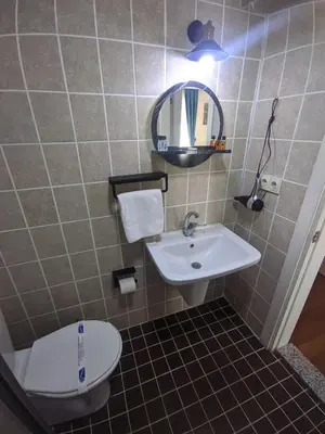 a bathroom with a sink and a toilet and a mirror at Rumeli Konak Butik Otel in Tekirdag
