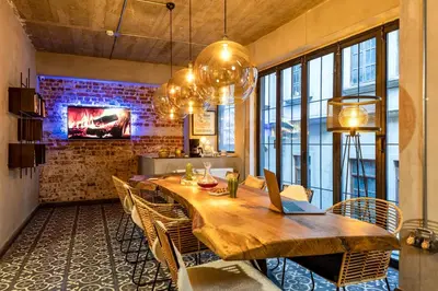 a dining room with a table with chairs and a laptop at Green Parrot Hotel Istanbul in Istanbul