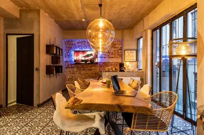a dining room with a table with chairs and a fireplace at Green Parrot Hotel Istanbul in Istanbul