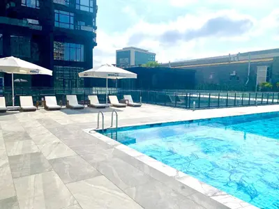 a swimming pool with chairs and umbrellas on a building at The G Hotels Istanbul in Istanbul