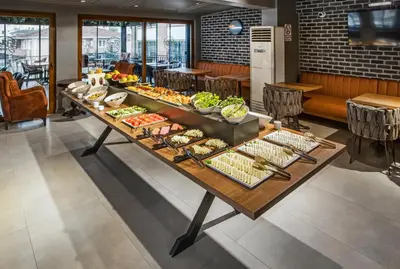 a buffet table with food on it in a restaurant at Luxon Hotel Sakarya in Sakarya