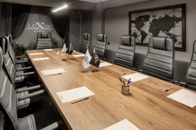 a conference room with a long wooden table and chairs at Luxon Hotel Sakarya in Sakarya