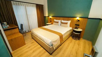 a bedroom with a large bed and a wooden floor at Fragments Hotel in Istanbul