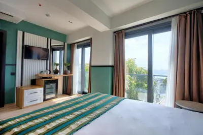 a bedroom with a large bed and large windows at Fragments Hotel in Istanbul
