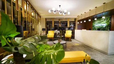 a lobby with yellow chairs and a reception desk at Fragments Hotel in Istanbul