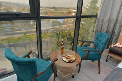 a room with two chairs and a table with a bottle of beer at MİLLS HOTEL in Tekirdag