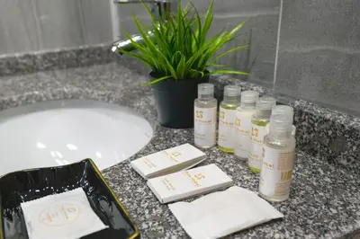 a bathroom counter with bottles of essential oils and a sink at MİLLS HOTEL in Tekirdag