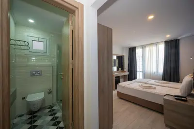 a bedroom with a bed and a shower and a bathroom at Okda Hotel in Istanbul