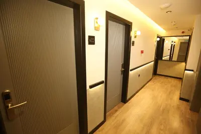 a corridor of a hallway with a door and wooden floors at Moja City Hotel in Istanbul