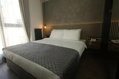 a bedroom with a large bed in a hotel room at Moja City Hotel in Istanbul