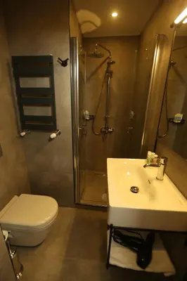 a bathroom with a toilet and a sink and a shower at Moja City Hotel in Istanbul