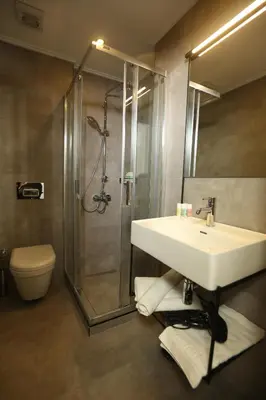 a bathroom with a sink and a shower and a toilet at Moja City Hotel in Istanbul