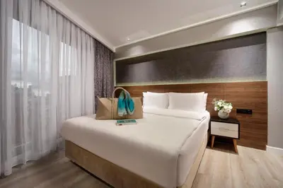a large white bed in a room with a window at Dora Pera Hotel in Istanbul