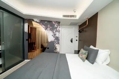 a bedroom with a large white bed with a window at Fama Karaköy in Istanbul