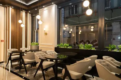 a restaurant with tables and chairs and plants at Fama Karaköy in Istanbul