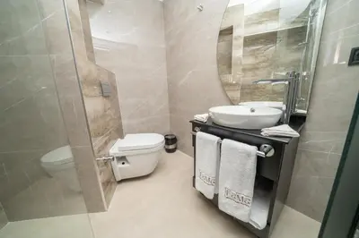 a bathroom with a sink and a toilet and a mirror at Fama Karaköy in Istanbul