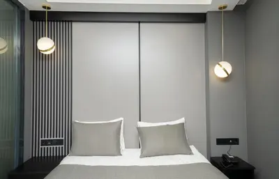 a bedroom with a bed with two lights and two pillows at Fama Karaköy in Istanbul