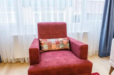 a red chair with a pillow on top of it at Altiyol Boga, Center of Kadıköy in Istanbul