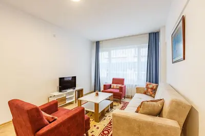 a living room with a couch and two chairs and a tv at Altiyol Boga, Center of Kadıköy in Istanbul