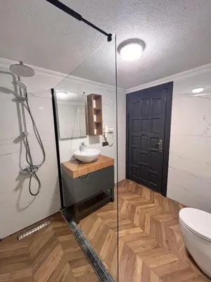 a bathroom with a sink and a glass door at Woodlodge Country Sapanca in Sapanca