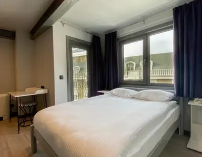 a bedroom with a large white bed with a window at Eresin Hotels Express in Istanbul