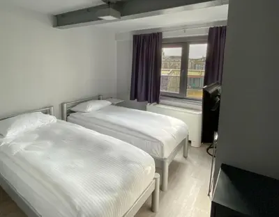 a hotel room with two beds and a window at Eresin Hotels Express in Istanbul