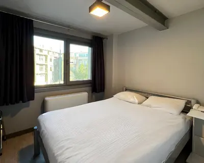 a bedroom with a white bed and a window at Eresin Hotels Express in Istanbul