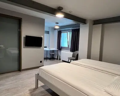a hotel room with a bed and a flat screen tv at Eresin Hotels Express in Istanbul