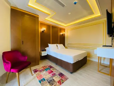 a hotel room with a bed and a red chair at Ak residence in Istanbul