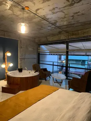 a bedroom with a bed and a table and chairs at Mas Suites Karaköy in Istanbul