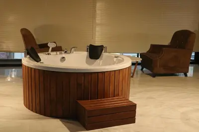a bath tub in a room with two chairs at Mas Suites Karaköy in Istanbul