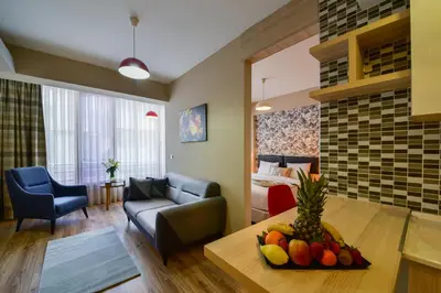 a living room with a couch and a table with fruit at La Flora House Hotel in Kocaeli