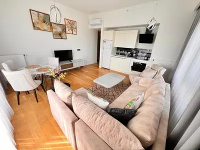 a living room with a couch and a table at G Tower Residence at Divan Near To Mimar Sinan Metro Station in Istanbul