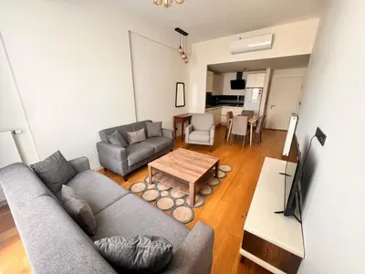 a living room with a couch and a table at G Tower Residence at Divan Near To Mimar Sinan Metro Station in Istanbul