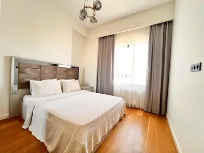 a bedroom with a white bed and a window at G Tower Residence at Divan Near To Mimar Sinan Metro Station in Istanbul