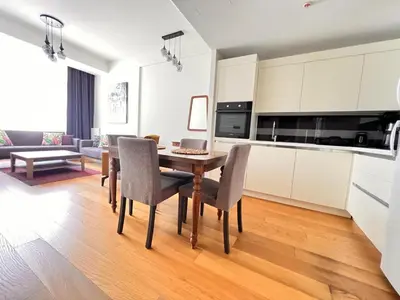 a kitchen and dining room with a table and chairs at G Tower Residence at Divan Near To Mimar Sinan Metro Station in Istanbul