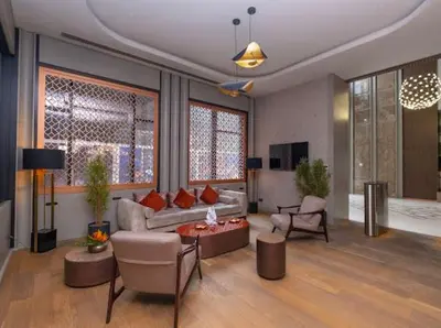a living room with a couch and a table at G Tower Residence at Divan Near To Mimar Sinan Metro Station in Istanbul